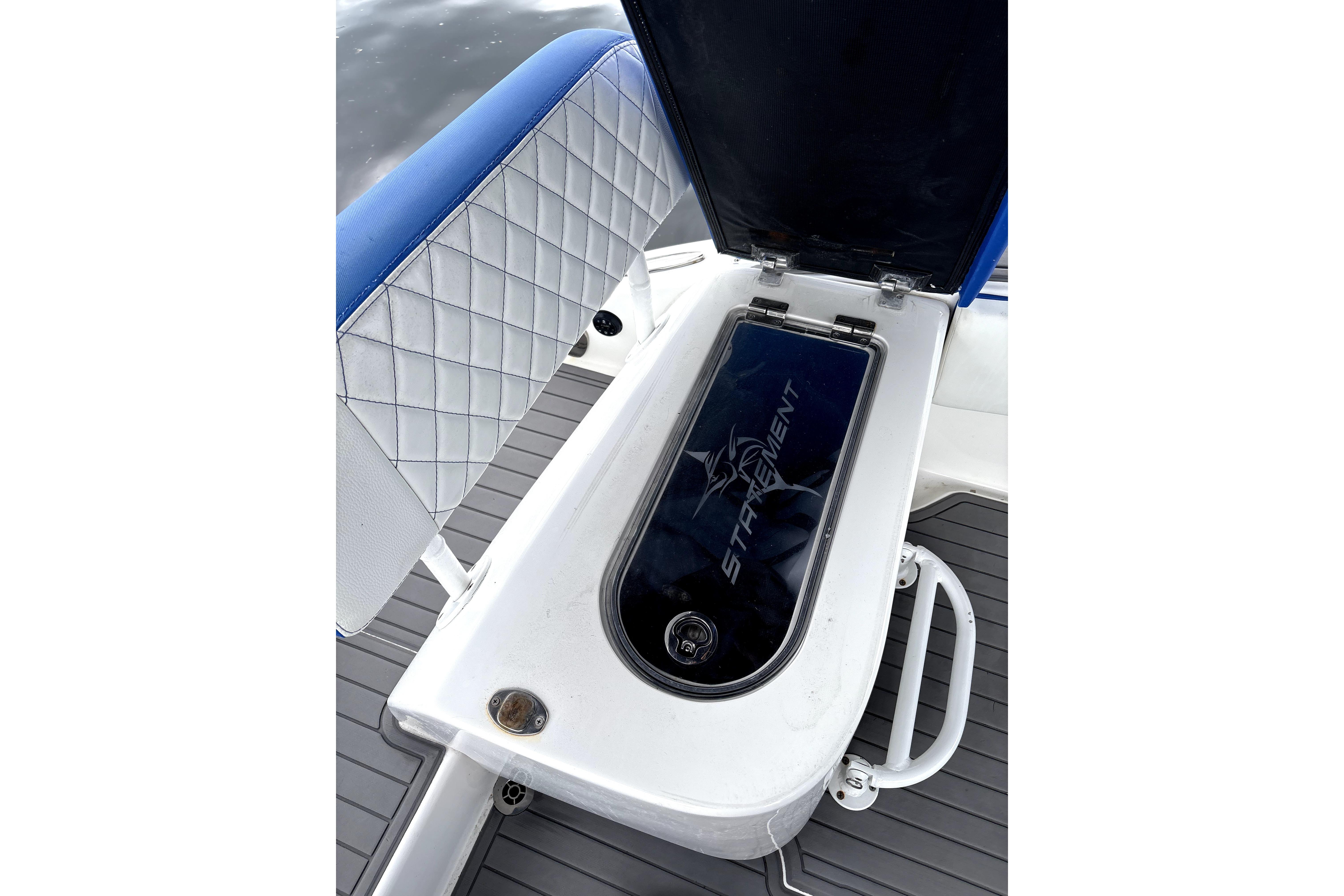 Open storage compartment on 2019 Statement Fishing Edition boat with cushioned seating.