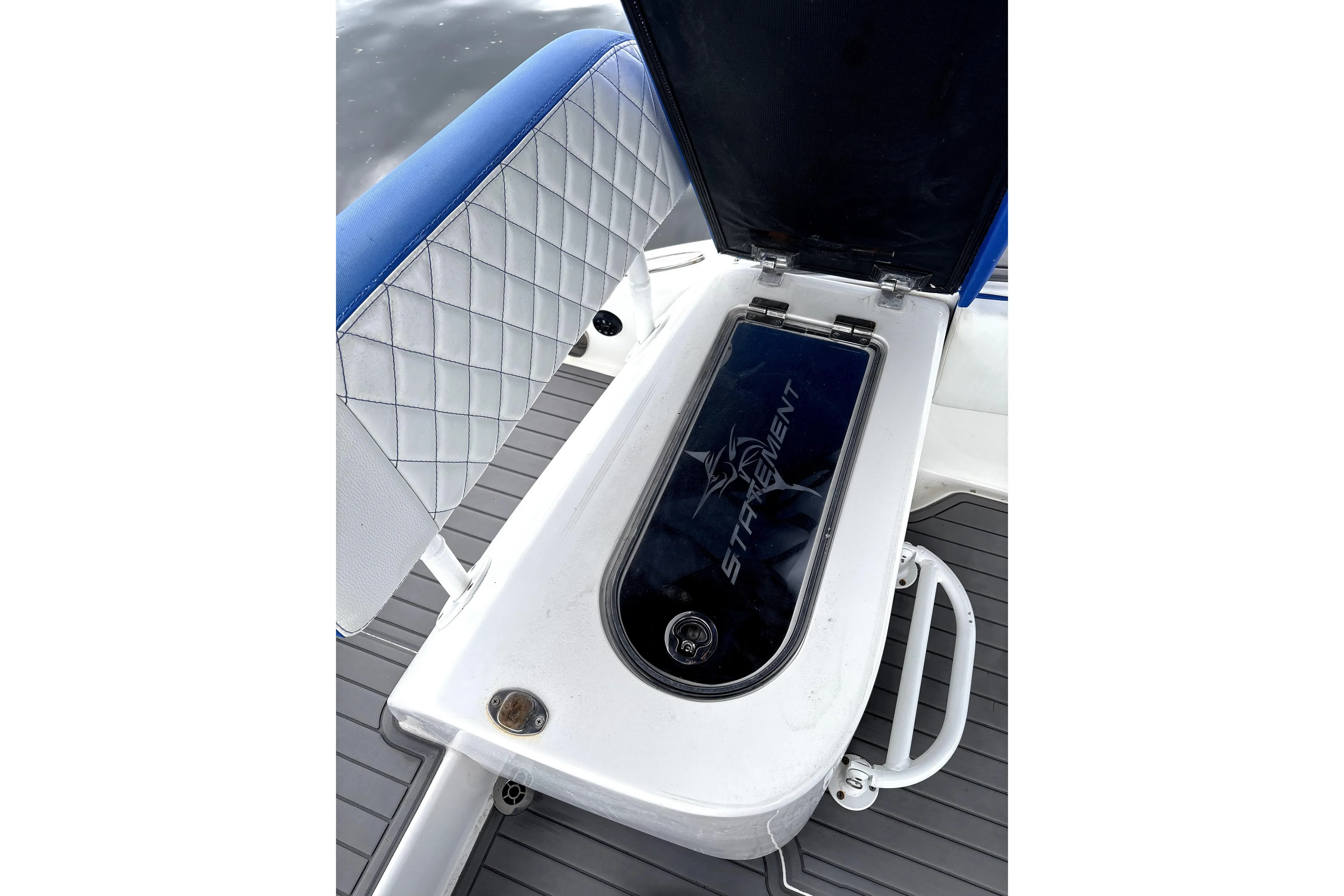 Open storage compartment on 2019 Statement Fishing Edition boat with cushioned seating.
