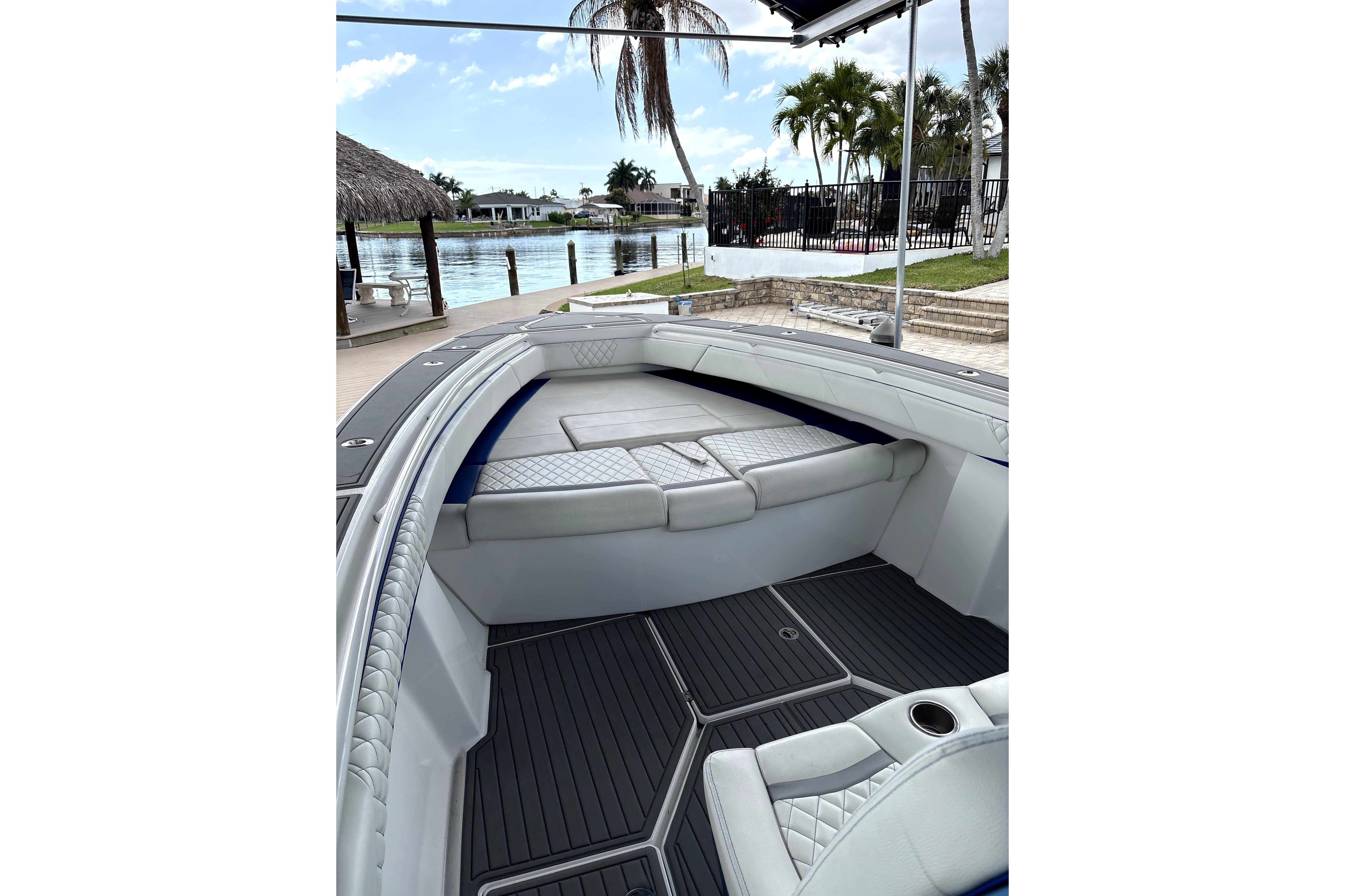 2019 Statement Fishing Edition boat interior with cushioned seating, dockside view.