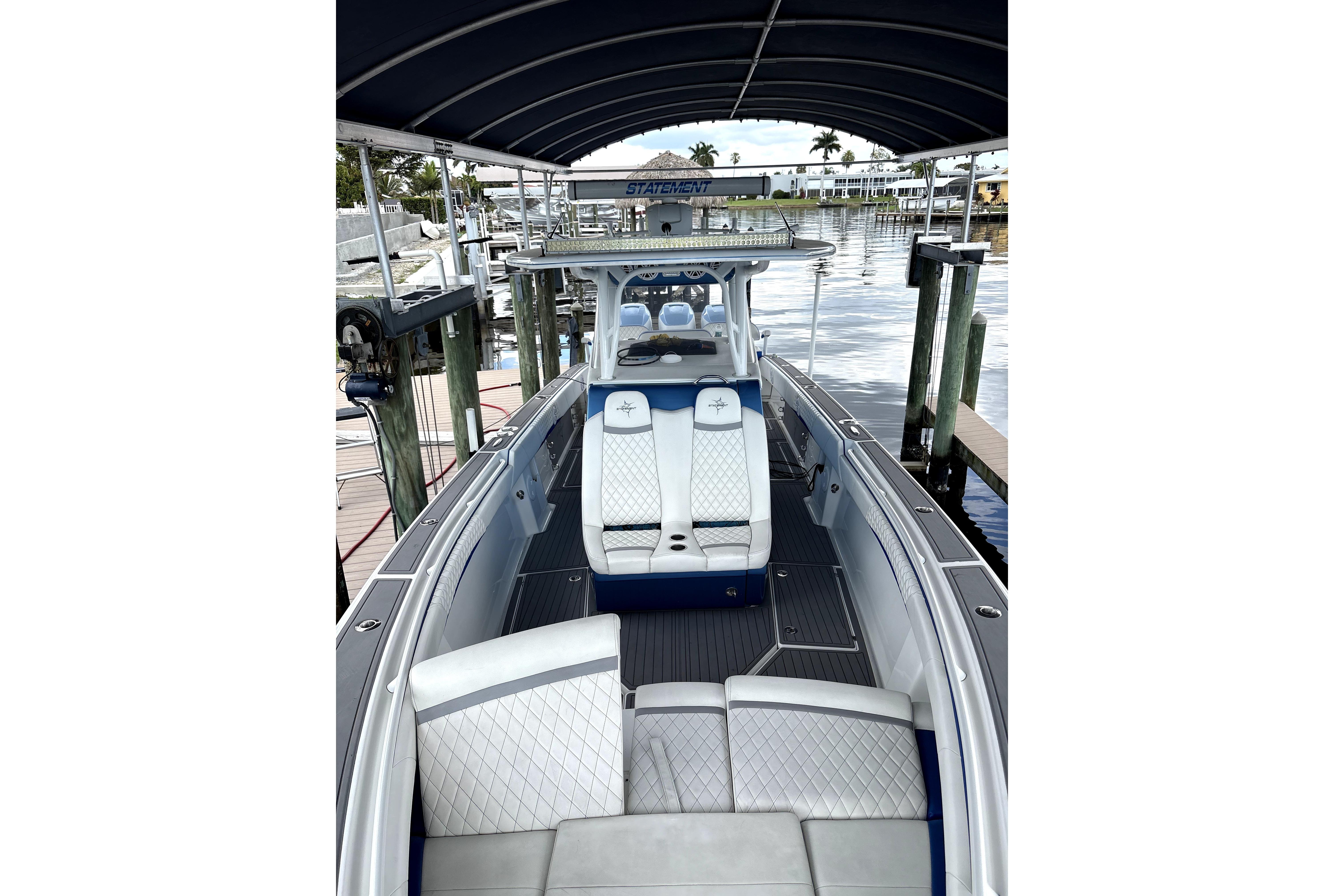 2019 Statement Fishing Edition boat with luxurious seating at a marina dock.
