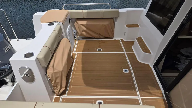  Yacht Photos Pics 2021 Ranger Tugs R-25 boat deck with cushioned seating and teak flooring.