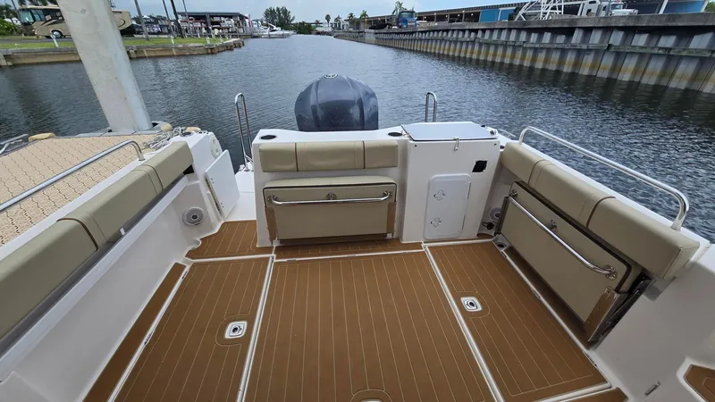  Yacht Photos Pics 2021 Ranger Tugs R-25 boat deck with seating, docked by a canal.