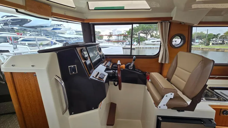  Yacht Photos Pics 2021 Ranger Tugs R-25 helm with modern controls and comfortable seating, dockside view.
