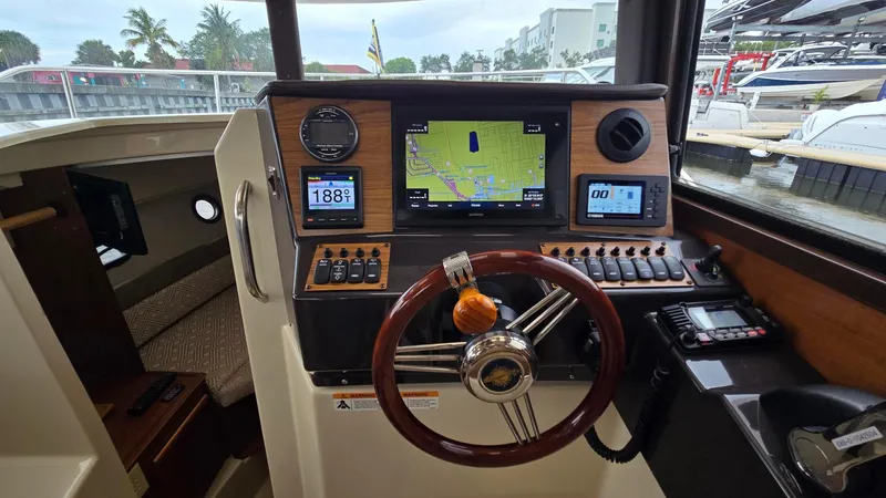  Yacht Photos Pics Interior helm of 2021 Ranger Tugs R-25 with navigation equipment and steering wheel.