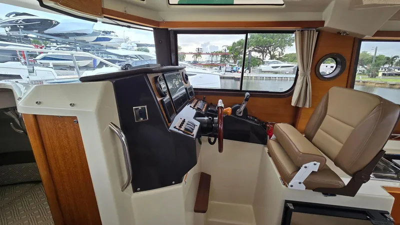  Yacht Photos Pics Interior of 2021 Ranger Tugs R-25 boat, featuring helm station and captain's chair.