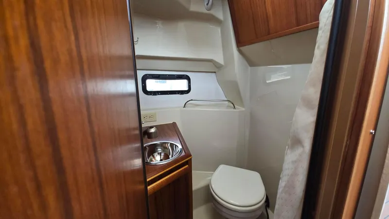  Yacht Photos Pics 2021 Ranger Tugs R-25 bathroom with wood accents and compact design.