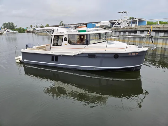  Yacht Photos Pics 2021 Ranger Tugs R-25 boat docked in a marina, calm water reflection.