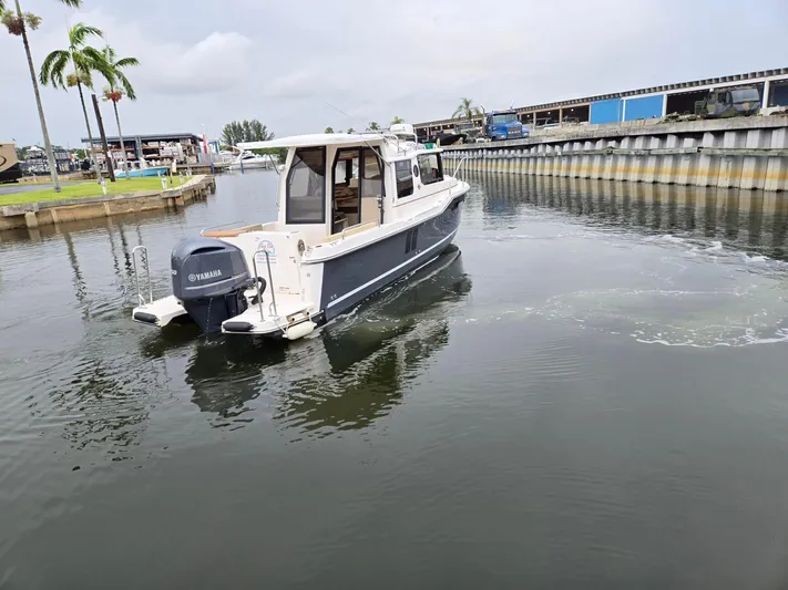  Yacht Photos Pics 2021 Ranger Tugs R-25 boat with Yamaha engine in a marina setting.