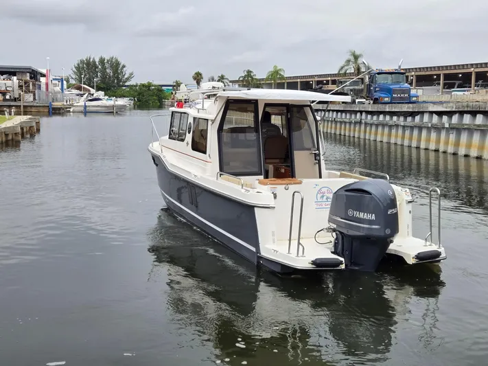  Yacht Photos Pics 2021 Ranger Tugs R-25 boat with Yamaha engine in a marina setting.