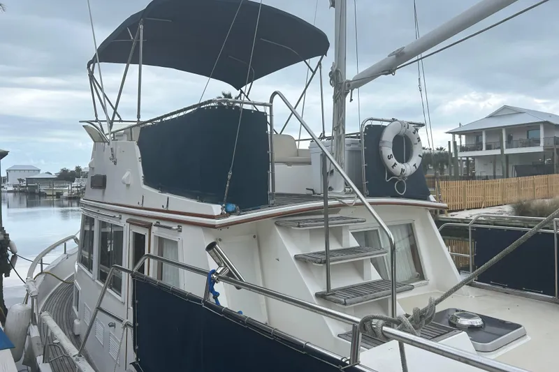  Yacht Photos Pics 1996 Grand Banks 36 Motoryacht docked, featuring upper deck and blue canopy.