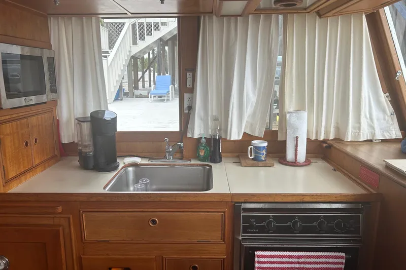 Yacht Photos Pics 1996 Grand Banks 36 Motoryacht kitchen with sink, microwave, and stove.