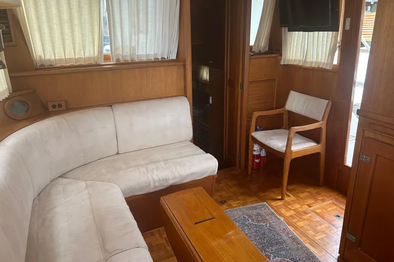  Yacht Photos Pics Interior of 1996 Grand Banks 36 Motoryacht with white seating and wooden accents.
