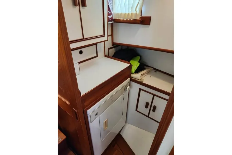  Yacht Photos Pics 1996 Grand Banks 36 Sedan interior with wood cabinetry and compact storage space.