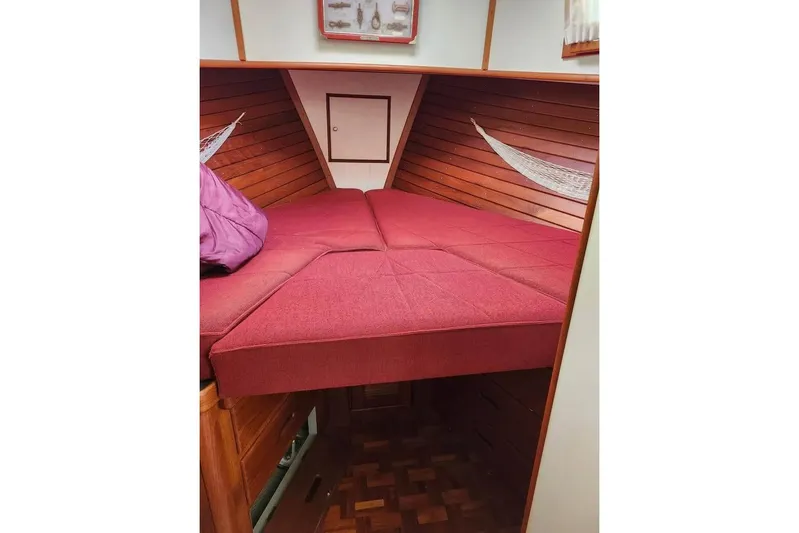  Yacht Photos Pics 1996 Grand Banks 36 Sedan interior with red cushioned bed and wooden paneling.