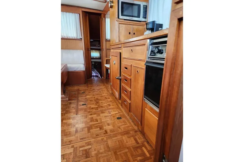  Yacht Photos Pics Interior of 1996 Grand Banks 36 Sedan with wood cabinetry and parquet flooring.
