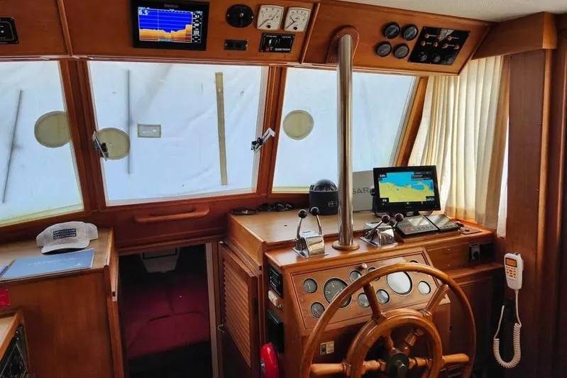  Yacht Photos Pics Interior of 1996 Grand Banks 36 Sedan boat with navigation equipment and wooden steering wheel.