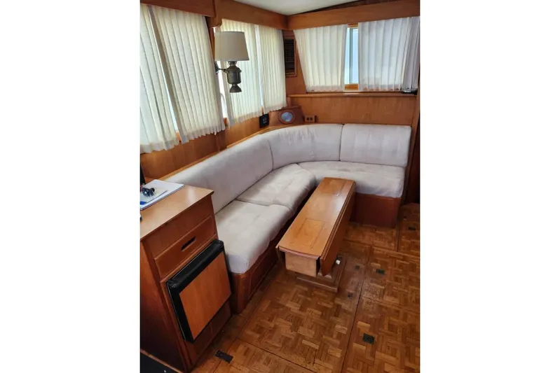  Yacht Photos Pics Interior of 1996 Grand Banks 36 Sedan with cozy seating and wooden accents.