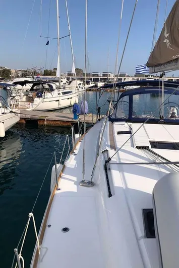 Misty Yacht Photos Pics 2018 Jeanneau Sun Odyssey 519 yacht docked in a marina, clear sky, calm waters.