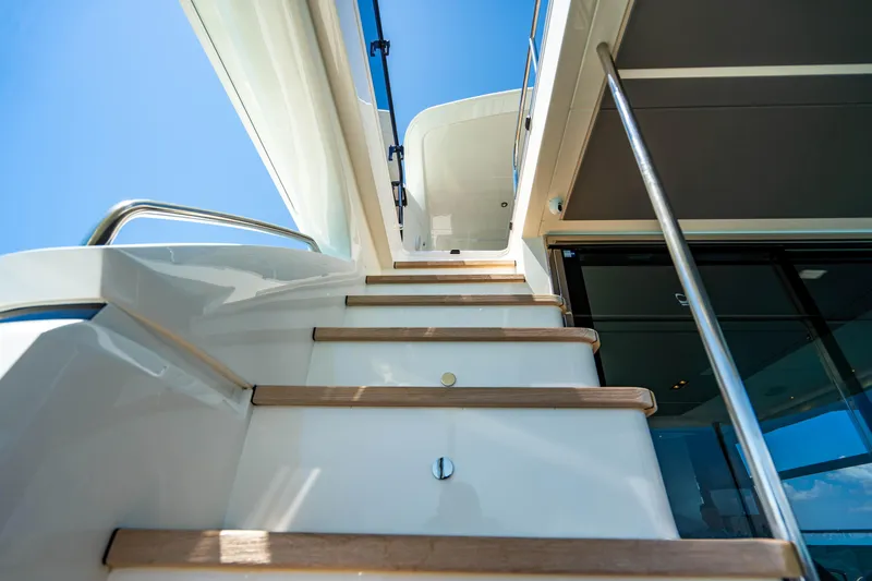 Comfortably Numb Yacht Photos Pics Staircase on 2018 Princess Y75 Motor Yacht under clear blue sky.