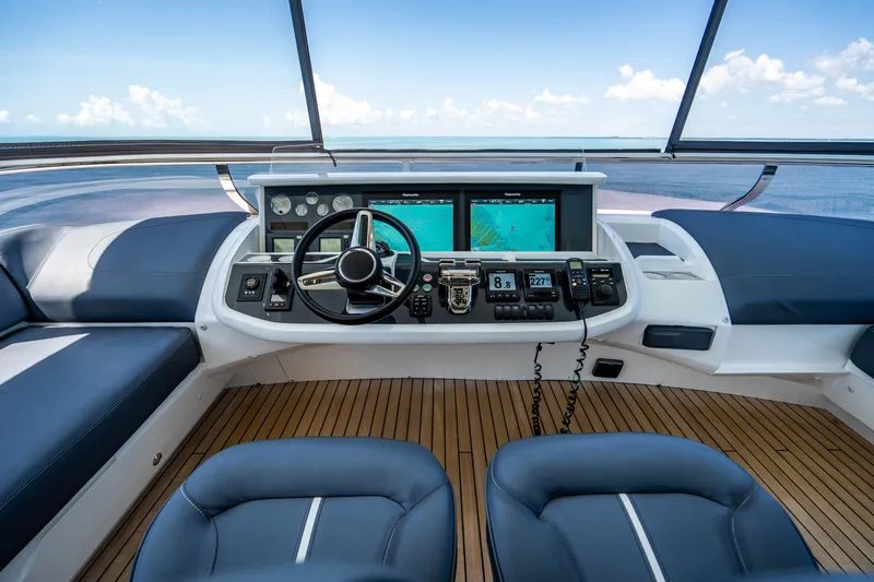Comfortably Numb Yacht Photos Pics Helm station of 2018 Princess Y75 Motor Yacht with navigation screens and ocean view.
