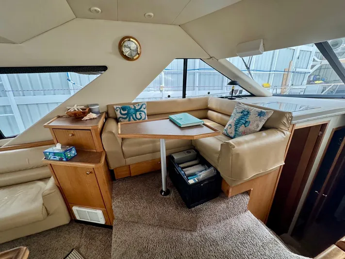 The Journey Yacht Photos Pics Interior of 1999 Bayliner 3988 Command Bridge Motoryacht with cozy seating and nautical decor.