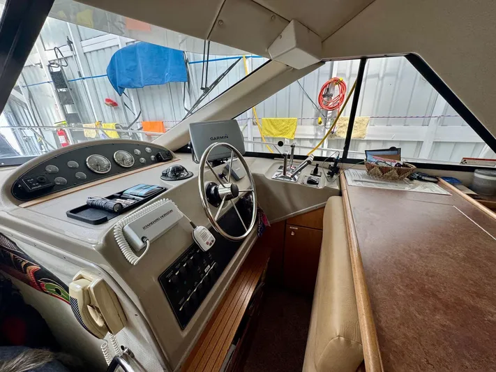 The Journey Yacht Photos Pics 1999 Bayliner 3988 Command Bridge Motoryacht helm with steering wheel, controls, and navigation equipment.