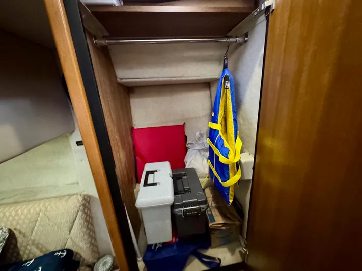 The Journey Yacht Photos Pics Storage closet in 1999 Bayliner 3988 Command Bridge Motoryacht with life jacket and boxes.