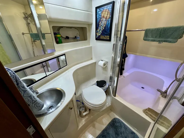 The Journey Yacht Photos Pics Bathroom interior of 1999 Bayliner 3988 Command Bridge Motoryacht, featuring sink, toilet, and shower.