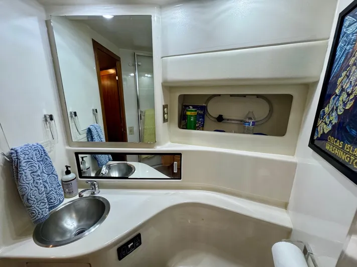 The Journey Yacht Photos Pics Bathroom interior of 1999 Bayliner 3988 Command Bridge Motoryacht with sink, mirror, and storage.