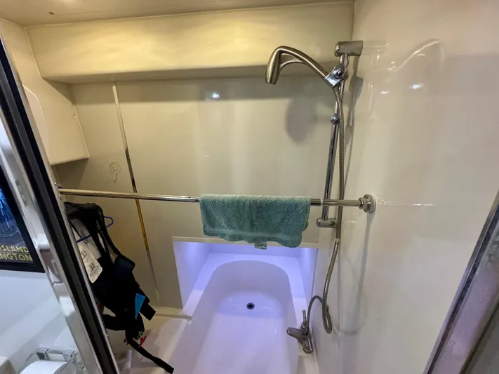 The Journey Yacht Photos Pics Shower area in 1999 Bayliner 3988 Command Bridge Motoryacht with towel and adjustable showerhead.