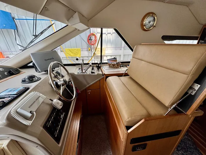 The Journey Yacht Photos Pics 1999 Bayliner 3988 Command Bridge Motoryacht helm with Garmin navigation and beige seating.