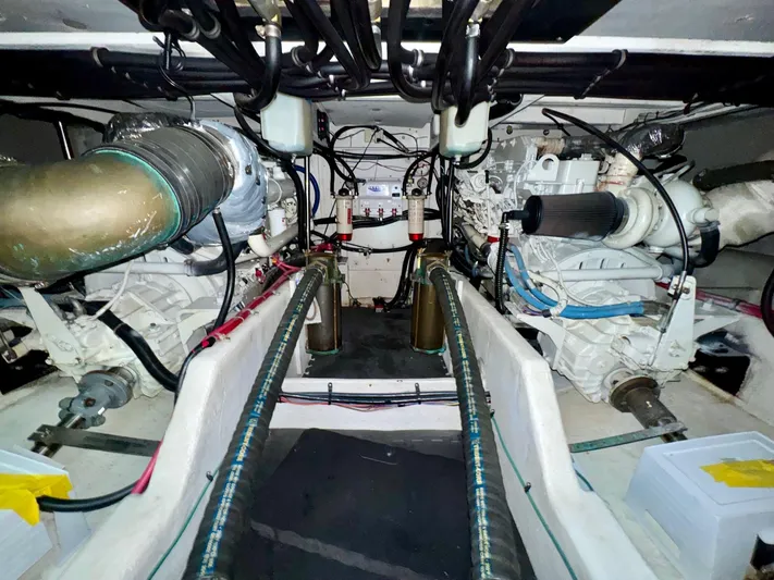 The Journey Yacht Photos Pics Engine room of 1999 Bayliner 3988 Command Bridge Motoryacht, showcasing dual engines and mechanical components.