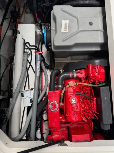 The Journey Yacht Photos Pics Engine compartment of a 1999 Bayliner 3988 Command Bridge Motoryacht, featuring red engine components.