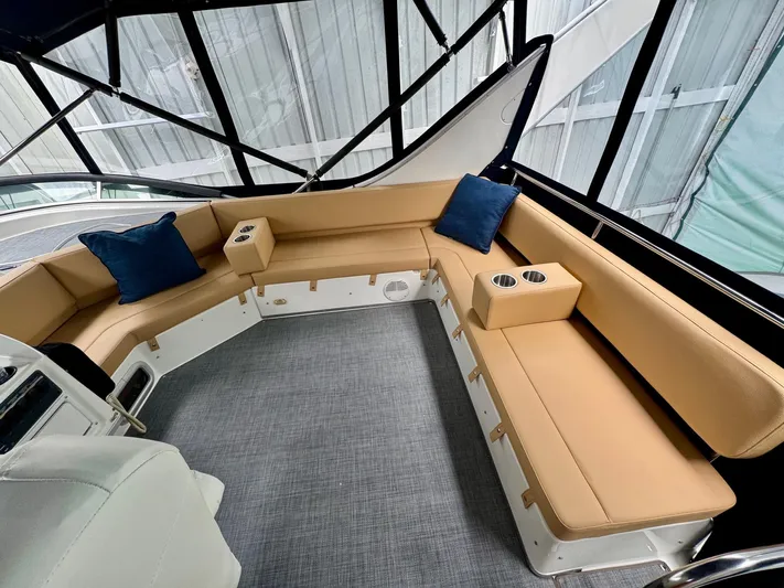 The Journey Yacht Photos Pics Luxurious seating area on 1999 Bayliner 3988 Command Bridge Motoryacht with tan cushions and blue pillows.