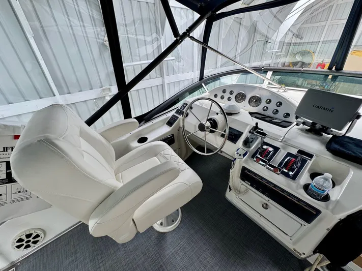 The Journey Yacht Photos Pics 1999 Bayliner 3988 Command Bridge Motoryacht helm with white captain's chair and navigation equipment.