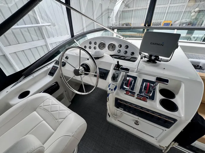 The Journey Yacht Photos Pics 1999 Bayliner 3988 Command Bridge Motoryacht helm with Garmin navigation system and control panel.