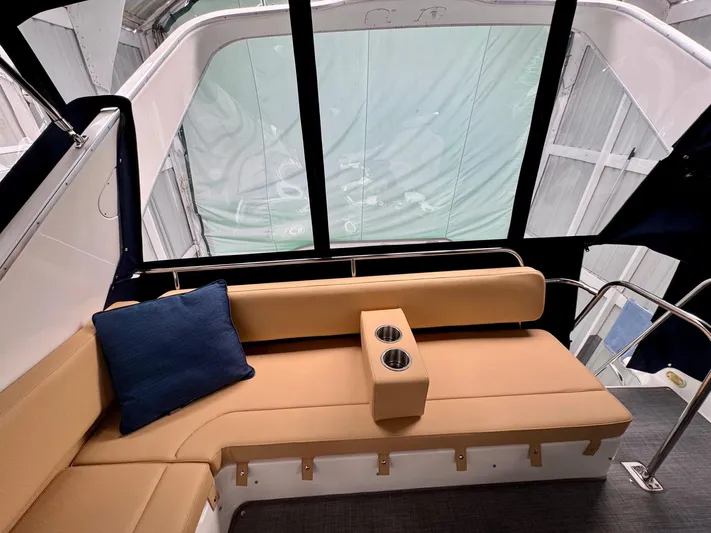 The Journey Yacht Photos Pics 1999 Bayliner 3988 Command Bridge Motoryacht interior with tan seating and blue cushion.