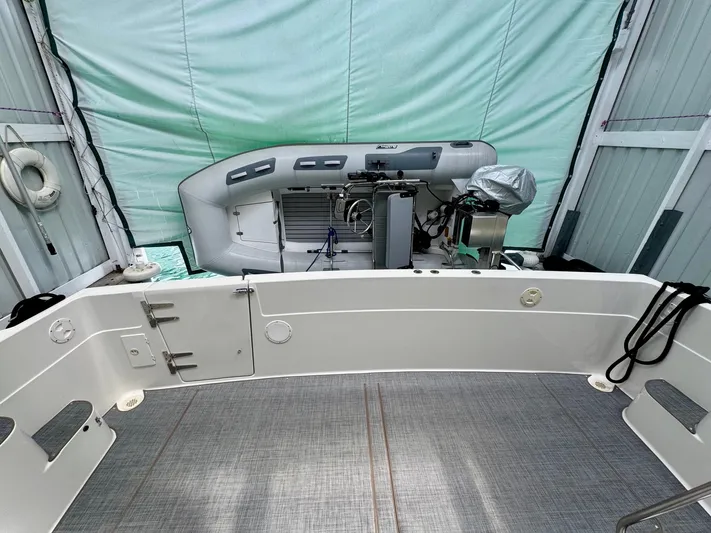 The Journey Yacht Photos Pics 1999 Bayliner 3988 Command Bridge Motoryacht cockpit with inflatable boat and covered engine.