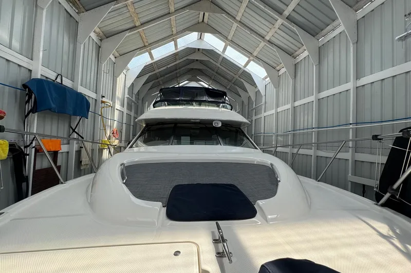 The Journey Yacht Photos Pics 1999 Bayliner 3988 Command Bridge Motoryacht in covered storage, showcasing sleek design.