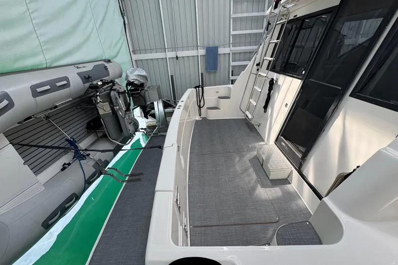 The Journey Yacht Photos Pics 1999 Bayliner 3988 Command Bridge Motoryacht with inflatable boat in storage facility.