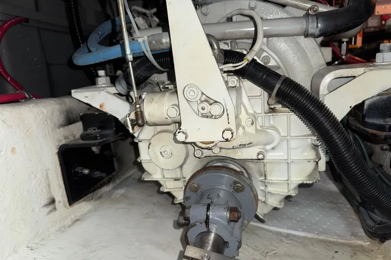 The Journey Yacht Photos Pics Engine compartment of a 1999 Bayliner 3988 Command Bridge Motoryacht, showing mechanical components and hoses.