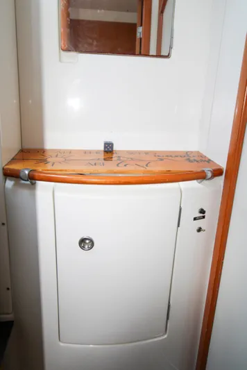 One Life Yacht Photos Pics Lagoon 410 2002 yacht bathroom with wooden countertop and mirror.