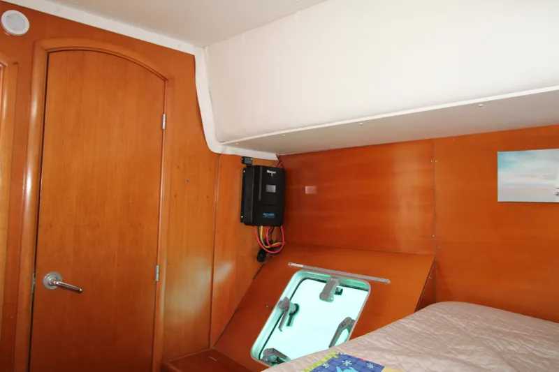 One Life Yacht Photos Pics Interior cabin of 2002 Lagoon 410 catamaran with wooden paneling and window.