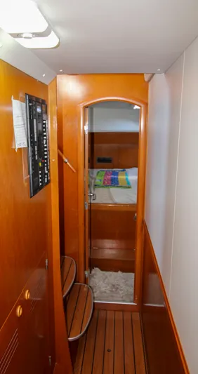 One Life Yacht Photos Pics Interior hallway of 2002 Lagoon 410 catamaran with wooden flooring and cozy cabin view.