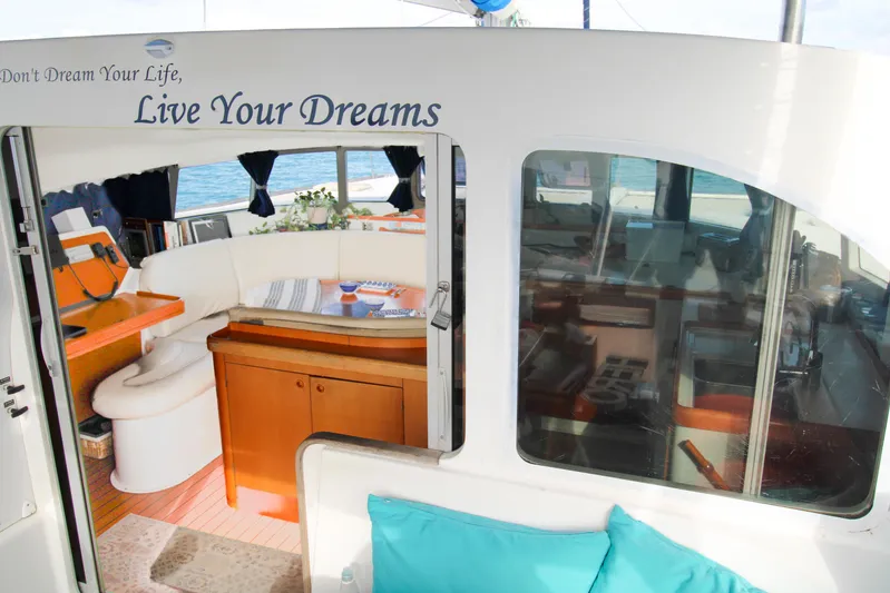 One Life Yacht Photos Pics Interior of 2002 Lagoon 410 catamaran with cozy seating and ocean view.