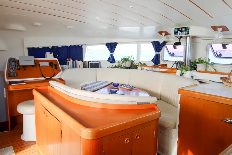One Life Yacht Photos Pics Spacious interior of 2002 Lagoon 410 catamaran with cozy seating and navigation area.