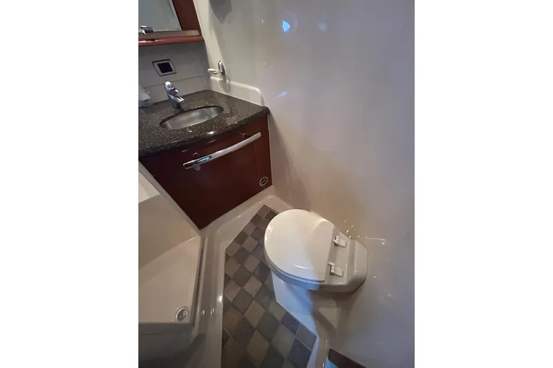 Blue Diamond Yacht Photos Pics 2005 Sea Ray 500 Sundancer bathroom with sink, toilet, and checkered floor.