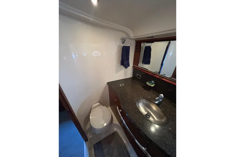 Blue Diamond Yacht Photos Pics Luxurious bathroom in 2005 Sea Ray 500 Sundancer yacht with granite countertop and modern fixtures.