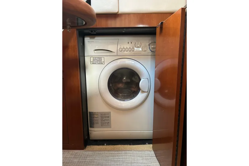 Blue Diamond Yacht Photos Pics Washing machine inside 2005 Sea Ray 500 Sundancer yacht, wooden cabinetry, compact design.