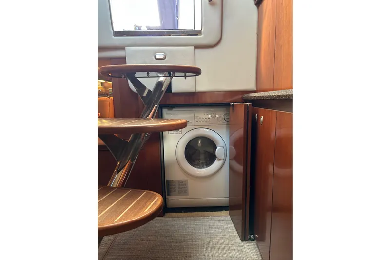 Blue Diamond Yacht Photos Pics 2005 Sea Ray 500 Sundancer interior with built-in washing machine under wooden stairs.